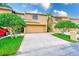 Attractive home with a well-maintained lawn, mature trees, and a two-car garage at 4212 Mill Valley Ct, Tampa, FL 33618