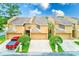 Desirable townhome showcasing a private garage, manicured front yard, and well-maintained facade at 4212 Mill Valley Ct, Tampa, FL 33618