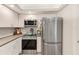 Modern kitchen with stainless steel refrigerator, white cabinets, and subway tile backsplash at 4212 Mill Valley Ct, Tampa, FL 33618