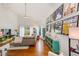 Bright living room with vaulted ceilings, wood floors, large windows, and eclectic decor at 4212 Mill Valley Ct, Tampa, FL 33618
