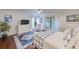 Serene primary bedroom with wood floors, neutral tones, and sliding glass door to outdoor space at 4212 Mill Valley Ct, Tampa, FL 33618
