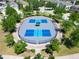 Aerial view of outdoor pickleball courts surrounded by lush greenery and neighborhood trees at 4513 Eternal Prince Dr, Sun City Center, FL 33573