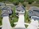 Aerial view of a two-story home with solar panels, surrounded by well-maintained lawns at 4513 Eternal Prince Dr, Sun City Center, FL 33573