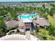 Beautiful aerial view of a community pool, surrounded by palm trees and neighborhood homes at 4513 Eternal Prince Dr, Sun City Center, FL 33573