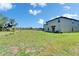 Large backyard with a patio and plenty of space for outdoor activities at 4513 Eternal Prince Dr, Sun City Center, FL 33573
