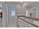 Bathroom featuring a double vanity with granite countertops and modern fixtures at 4513 Eternal Prince Dr, Sun City Center, FL 33573