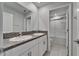 Bathroom featuring a double sink vanity with granite countertop and tile flooring and walk in shower at 4513 Eternal Prince Dr, Sun City Center, FL 33573