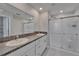 Bathroom features double sinks, a granite countertop, and a glass shower enclosure at 4513 Eternal Prince Dr, Sun City Center, FL 33573