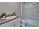 Full bathroom featuring a granite countertop vanity, toilet, and shower at 4513 Eternal Prince Dr, Sun City Center, FL 33573