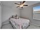 This bedroom features a ceiling fan, window, and a comfortable bed with a plush elephant at 4513 Eternal Prince Dr, Sun City Center, FL 33573