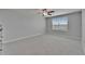 Bright, carpeted bedroom featuring a ceiling fan and a large window at 4513 Eternal Prince Dr, Sun City Center, FL 33573
