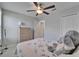 Bedroom featuring a ceiling fan, dresser, closet, door and a comfortable bed with a plush toy at 4513 Eternal Prince Dr, Sun City Center, FL 33573