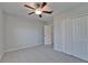 Bedroom featuring carpet floor, ceiling fan, closet and door at 4513 Eternal Prince Dr, Sun City Center, FL 33573