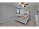 Charming bedroom featuring a ceiling fan, window, and neutral decor with a cozy, carpeted floor at 4513 Eternal Prince Dr, Sun City Center, FL 33573