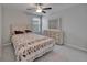 Bright bedroom featuring a ceiling fan, neutral walls, a comfortable bed, and a modern dresser at 4513 Eternal Prince Dr, Sun City Center, FL 33573