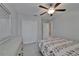 View of a light and airy bedroom with closet, door, dresser and a patterned bedspread at 4513 Eternal Prince Dr, Sun City Center, FL 33573