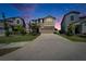 Lovely two-story home featuring a well-manicured lawn and a spacious driveway at twilight at 4513 Eternal Prince Dr, Sun City Center, FL 33573