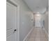 Hallway with tile flooring showcasing a staircase leading to the upper level and a white front door at 4513 Eternal Prince Dr, Sun City Center, FL 33573