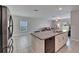 Open concept kitchen featuring granite countertops, white cabinets, and modern appliances at 4513 Eternal Prince Dr, Sun City Center, FL 33573