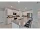 Modern kitchen with stainless steel appliances, granite countertops, and white cabinets at 4513 Eternal Prince Dr, Sun City Center, FL 33573