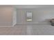 Spacious living room area with neutral paint, tile floor and a bright window at 4513 Eternal Prince Dr, Sun City Center, FL 33573