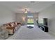 Comfortable living room with sliding glass doors leading to the backyard at 4513 Eternal Prince Dr, Sun City Center, FL 33573