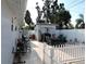 Back yard features a tile patio area, storage shed, and white picket fence, ideal for outdoor activities at 4529 W Knox St, Tampa, FL 33614