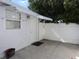 Backyard entry with awning and small window with white privacy fence at 4529 W Knox St, Tampa, FL 33614