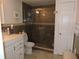 Updated bathroom with a glass-enclosed shower, modern vanity, and neutral-toned tile at 4529 W Knox St, Tampa, FL 33614