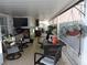 Enclosed patio with tile flooring, comfortable seating, a TV, and hanging plants, creating a relaxing atmosphere at 4529 W Knox St, Tampa, FL 33614