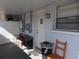 Exterior view of a covered patio featuring 4 chairs and other furnishings at 4529 W Knox St, Tampa, FL 33614