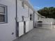 Side view of the house showcasing its clean exterior, windows, and outdoor electrical infrastructure at 4529 W Knox St, Tampa, FL 33614