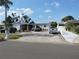 Charming single-story home with a large driveway, complemented by manicured landscaping and a palm tree at 4529 W Knox St, Tampa, FL 33614