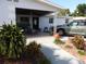 Inviting front porch with decorative plants, a rocking chair, and stylish exterior features at 4529 W Knox St, Tampa, FL 33614