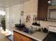 Galley kitchen featuring stainless steel sink, tile backsplash, and wood cabinets at 4529 W Knox St, Tampa, FL 33614