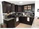 Stylish kitchen with stainless steel appliances, granite countertops, and dark cabinetry at 4529 W Knox St, Tampa, FL 33614
