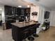 Modern kitchen featuring dark cabinets, granite countertops, and stainless steel appliances, perfect for cooking at 4529 W Knox St, Tampa, FL 33614