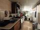 Galley kitchen with stainless appliances, a dog house, and a view to the outside at 4529 W Knox St, Tampa, FL 33614
