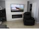 This living room features an electric fireplace, modern tv, and cozy recliner at 4529 W Knox St, Tampa, FL 33614