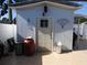 Outbuilding features secure door and covered area with paver patio and privacy fence at 4529 W Knox St, Tampa, FL 33614