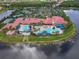 Beautiful community clubhouse features a large pool area, tennis courts, and manicured landscaping, all situated on a waterfront property at 4917 Sandy Brook Crk, Wimauma, FL 33598