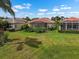 Well-maintained backyard features lush landscaping, a manicured lawn, and beautiful screened-in patios at 4917 Sandy Brook Crk, Wimauma, FL 33598