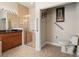 Bathroom featuring a glass door shower, vanity, toilet, and convenient grab bars for accessibility at 4917 Sandy Brook Crk, Wimauma, FL 33598