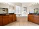 Spacious bathroom with dual sinks, corner tub, granite counters, and modern tile flooring at 4917 Sandy Brook Crk, Wimauma, FL 33598