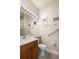Bathroom features a toilet, grab bars, a sink, vanity and mirror, and a glass door shower at 4917 Sandy Brook Crk, Wimauma, FL 33598