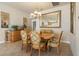 Dining room with oval table, light fixture, large mirror, and serving buffet at 4917 Sandy Brook Crk, Wimauma, FL 33598