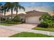 Beautiful single Gathering home with a tile roof, two-car garage and a red brick driveway at 4917 Sandy Brook Crk, Wimauma, FL 33598
