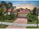 Beautiful single Gathering home with a tile roof, two-car garage and a red brick driveway at 4917 Sandy Brook Crk, Wimauma, FL 33598