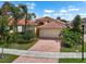 Beautiful single Gathering home with a tile roof, two-car garage and a red brick driveway at 4917 Sandy Brook Crk, Wimauma, FL 33598