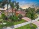 Beautiful single Gathering home with a tile roof, two-car garage and a red brick driveway at 4917 Sandy Brook Crk, Wimauma, FL 33598